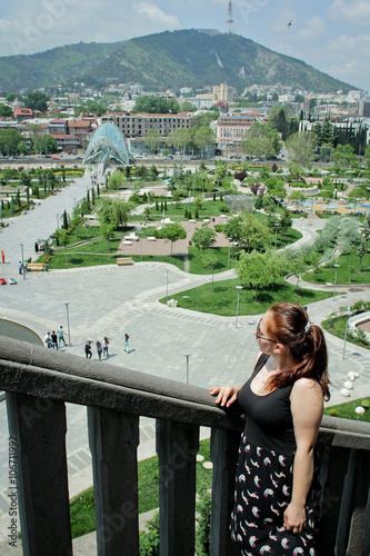 Girl looking panoramic view of Tbilisi, Georgia. Walk in the city center in Tbilisi photo