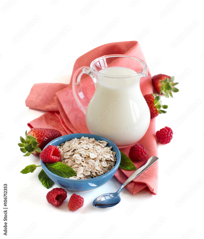 Rolled oats in a bowl with berries and milk Rolled oats in a bowl with berries and milk