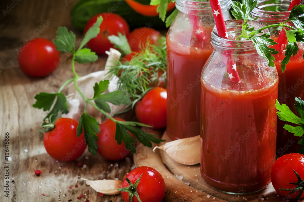 Smoothies of tomatoes and spices in glass bottles with festive r Smoothies of tomatoes and spices in glass bottles with festive r