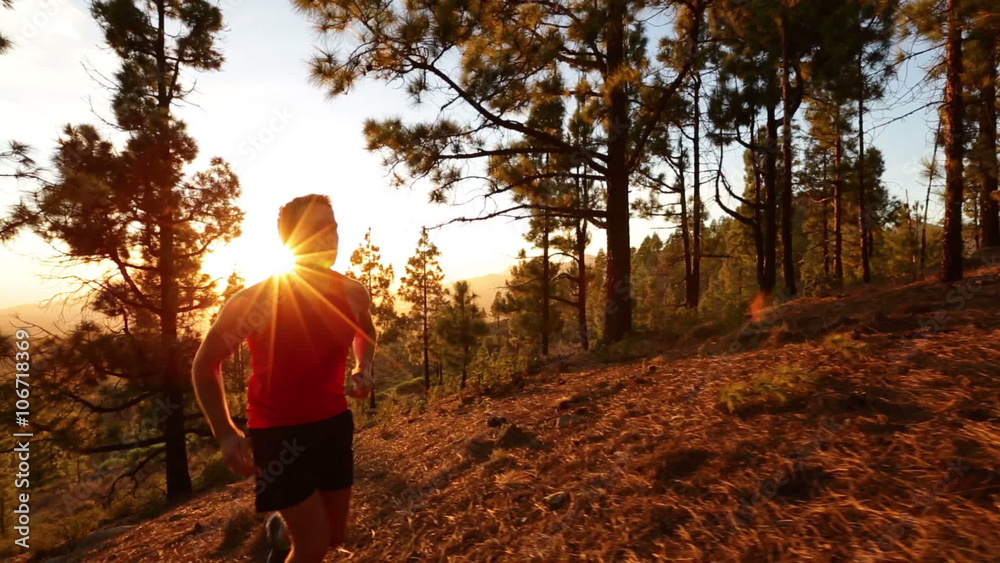Running runner man athlete training outdoors exercising on mountain forest trail at sunset in amazing landscape nature. Fit handsome athletic male working out for marathon run outside in summer. Running runner man athlete training outdoors exercising on mountain forest trail at sunset in amazing landscape nature. Fit handsome athletic male working out for marathon run outside in summer.