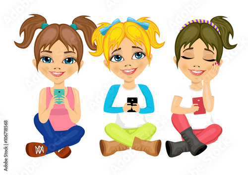 three cute little girls sitting on floor using their smartphones smiling happy