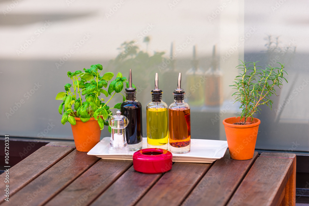 Cafe table with herbs and condiments Cafe table with herbs and condiments