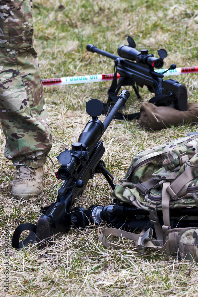 Military sniper aims at a target