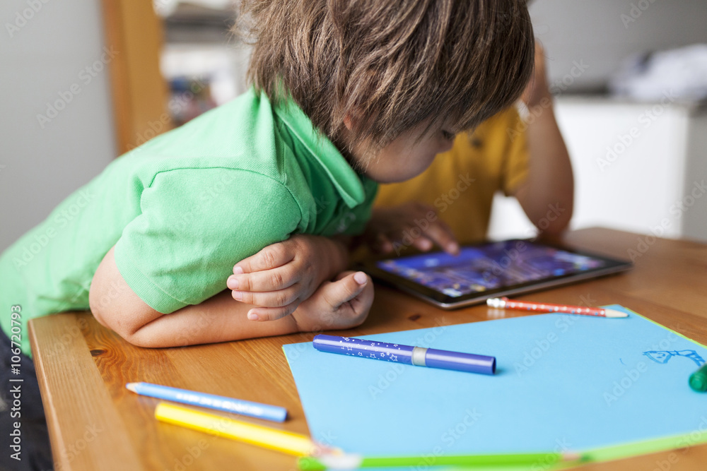 Two little brothers playing with digital tablet Two little brothers playing with digital tablet