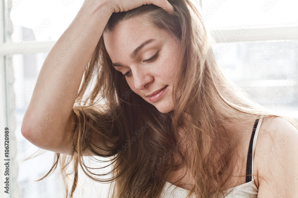 Portrait of smiling young woman with hand in her hair Portrait of smiling young woman with hand in her hair