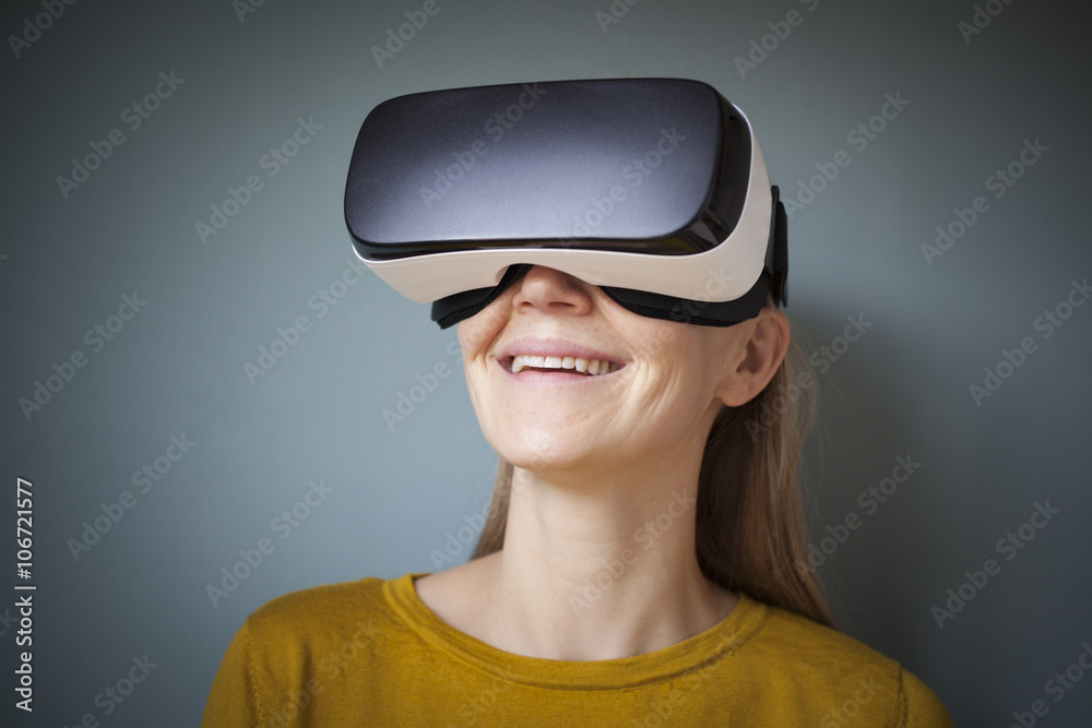 Smiling woman wearing Virtual Reality Glasses Smiling woman wearing Virtual Reality Glasses