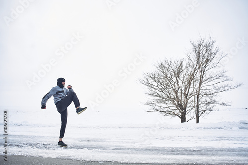 Athlete warming up in the winter on the nature