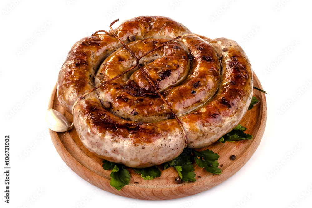 fried pork sausages on a barbecue on a wooden plate with cherry tomatoes and hot peppers fried pork sausages on a barbecue on a wooden plate with cherry tomatoes and hot peppers