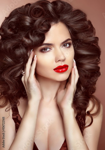Red lips. Makeup. Healthy hair. Beautiful brunette girl with lon