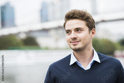 Germany, Hesse, Frankfurt, portrait of smiling young man photo