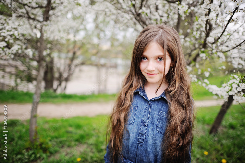 Kid girl in blooming garden Kid girl in blooming garden