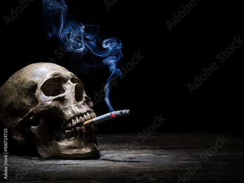 Still life skull and cigarette people smoke cigarette and get to