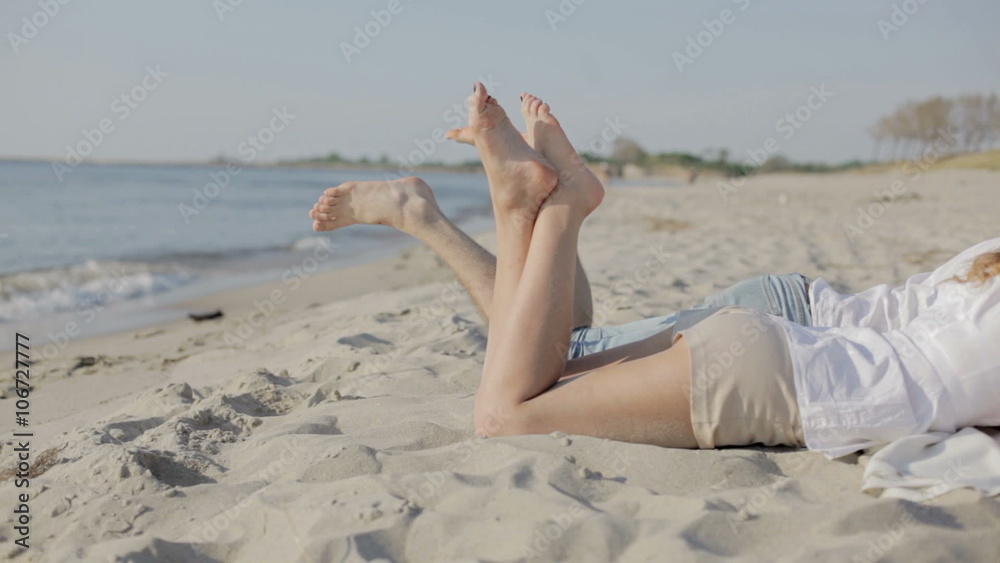 Man and woman's feet on resort beach Man and woman's feet on resort beach