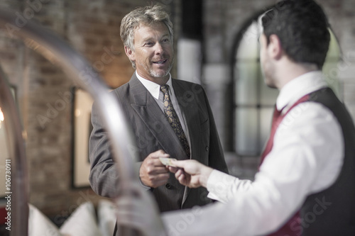Man in hotel room with bellboy