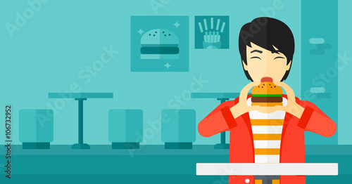 Man eating hamburger. 