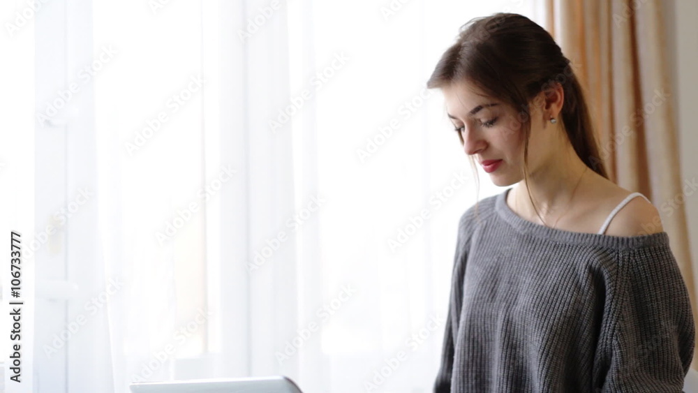 Young businesswoman working on her laptop in her cabinet at home. Young businesswoman working on her laptop in her cabinet at home.