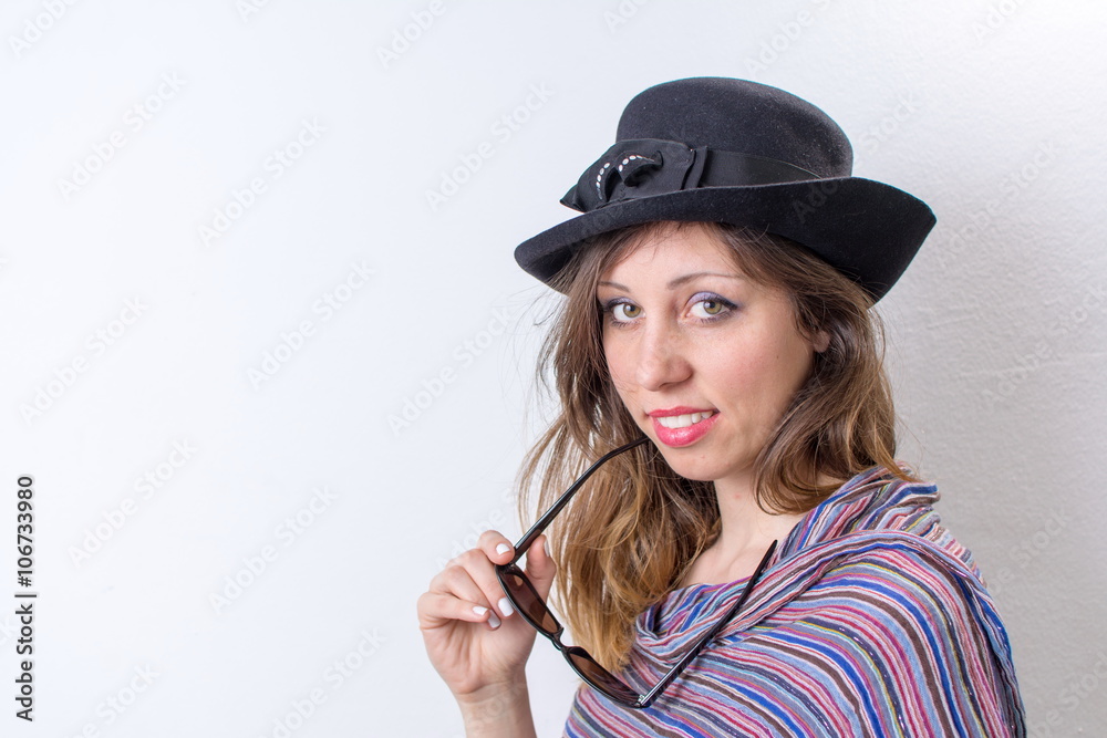 Happy girl posing with a hat and sunglasses Happy girl posing with a hat and sunglasses