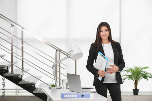 Pregnant woman at work in t...