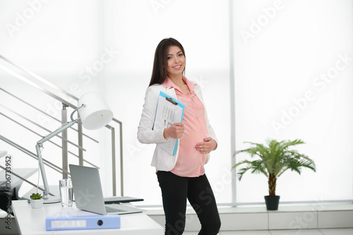 Pregnant woman at work in t...