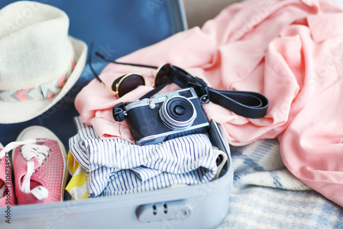 Woman's clothes in a grey suitcase, close up