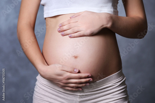 Wallpaper Mural Pregnant woman on grey wall background Torontodigital.ca