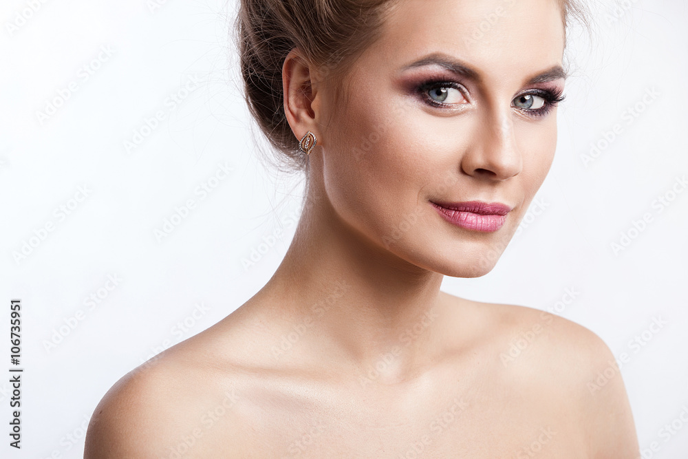Beauty model girl with perfect make-up isolated over white. Portrait of attractive young woman with blond hair on white background. Beautiful female face with clear fresh skin