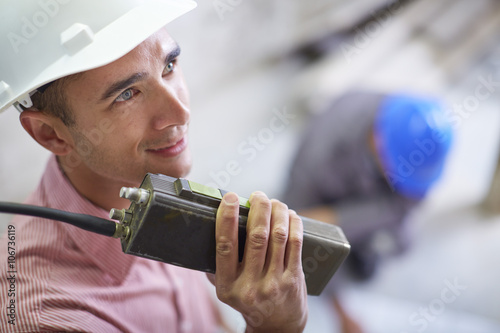 Construction worker talking on two-way radio