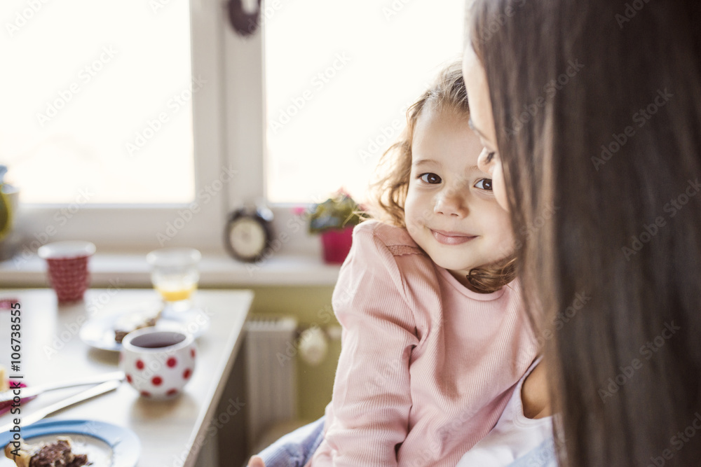 Portrait of smiling little girl cuddling with mother Portrait of smiling little girl cuddling with mother