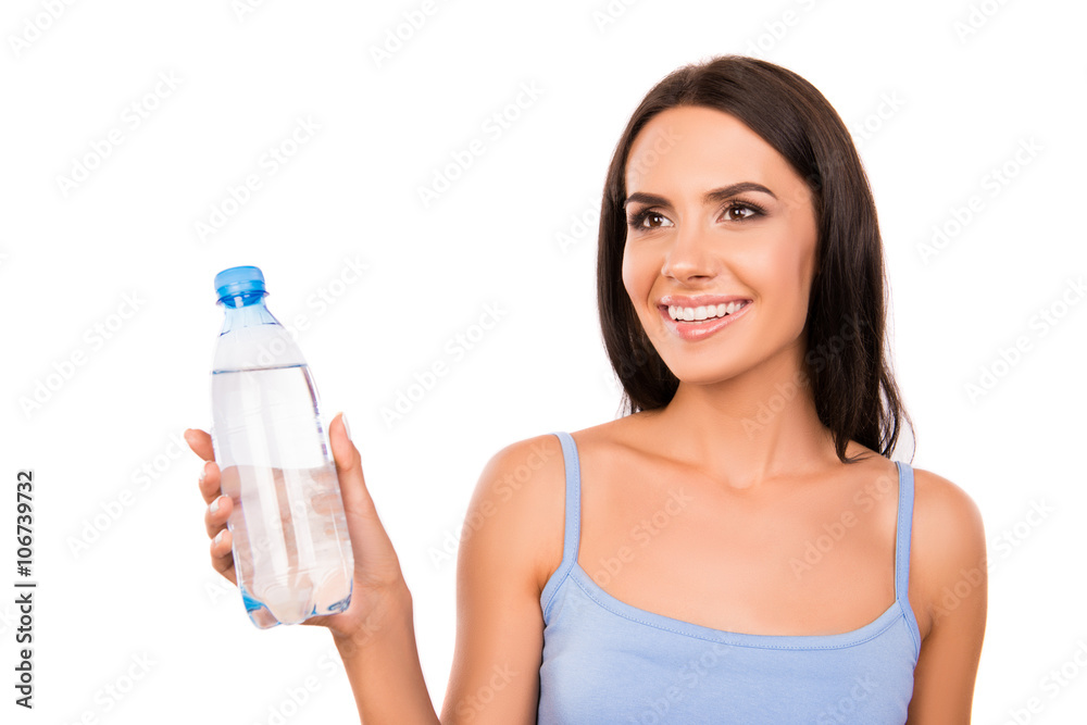 Cheerful happy brunette holding a bottle with fresh water Cheerful happy brunette holding a bottle with fresh water