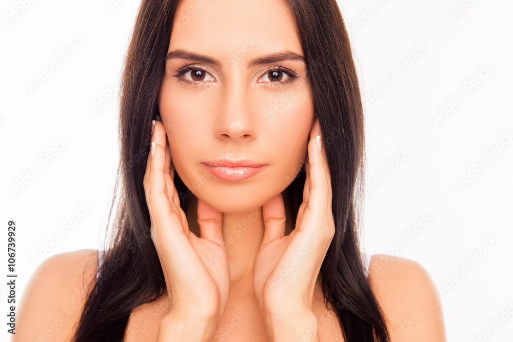 Portrait of serious attractive girl touching her face Portrait of serious attractive girl touching her face