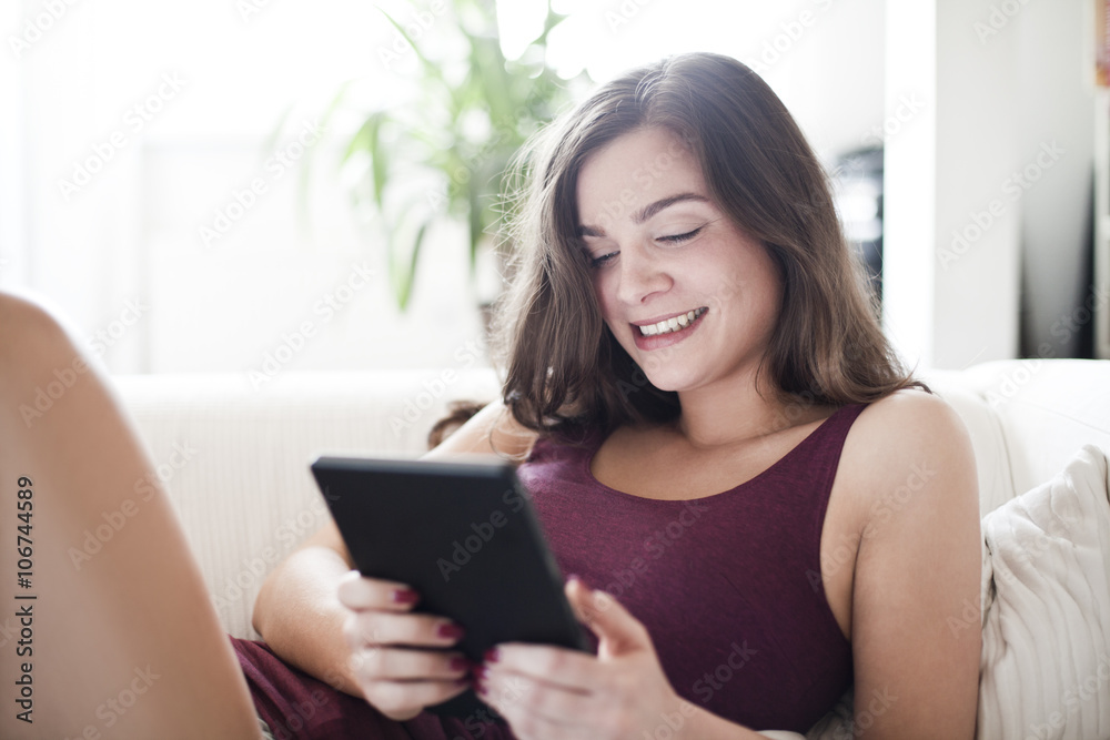 Portrait of smiling young woman with tablet computer at home Portrait of smiling young woman with tablet computer at home
