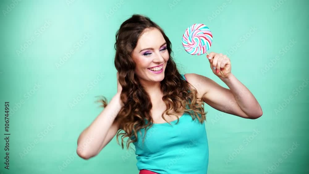 Woman smiling girl with lollipop candy on green 4K Woman smiling girl with lollipop candy on green 4K