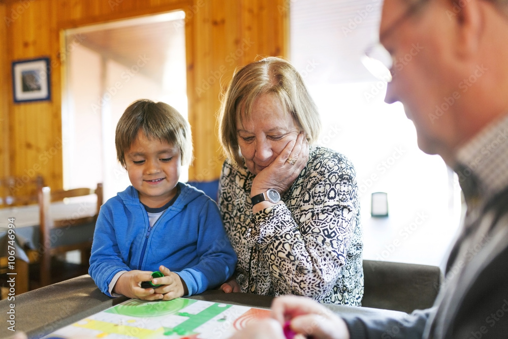 Grandparents playing ludo their grandson Grandparents playing ludo their grandson