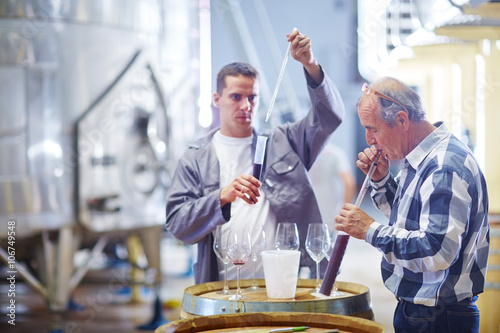 Wine makers testing wine blend