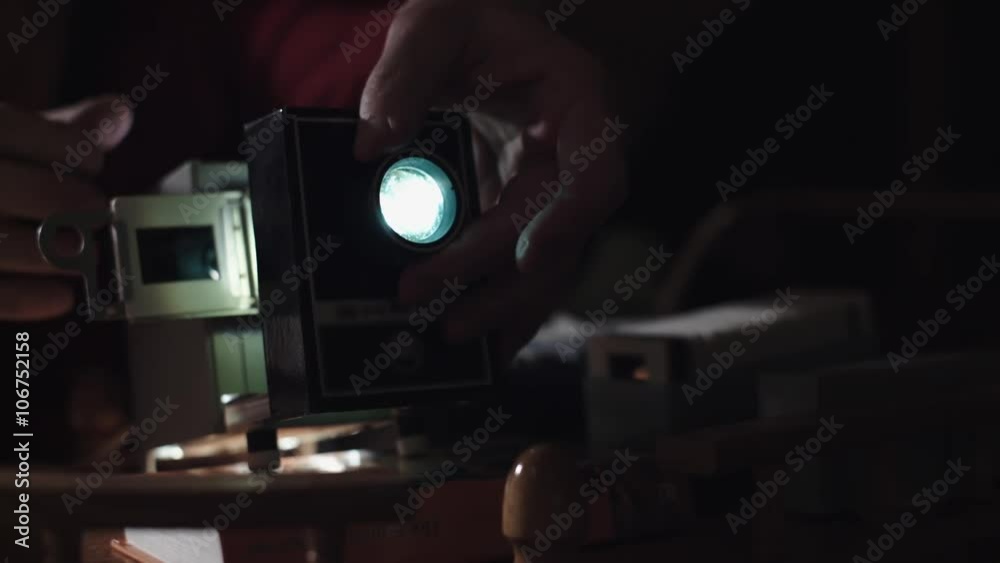 Man shows photos on the slide projector 