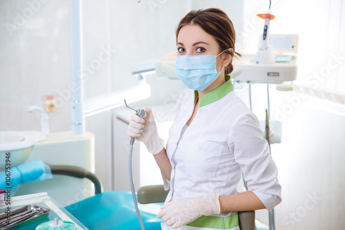 Dentist woman with medical instruments in the dental office