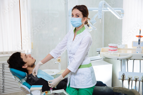 Dentist woman doing the procedure in the dental office