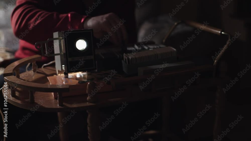 Man shows photos on the slide projector 