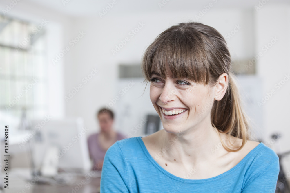 Portrait of laughing young woman in an creative office Portrait of laughing young woman in an creative office