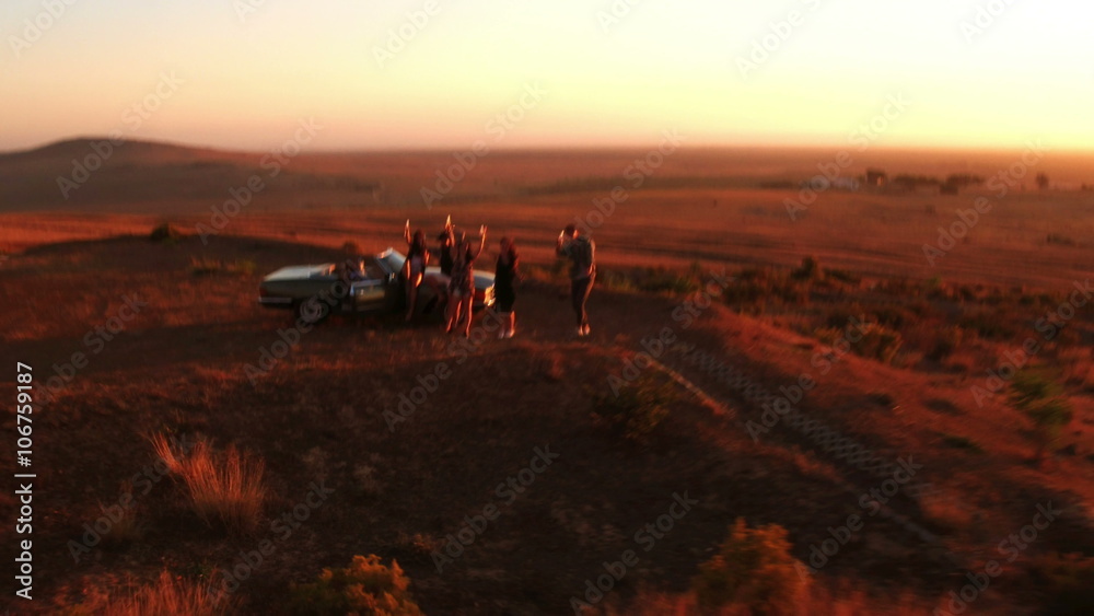 Friends at sunset on an american road trip Friends at sunset on an american road trip