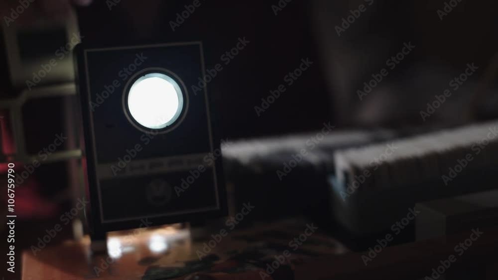 Man shows photos on the slide projector 