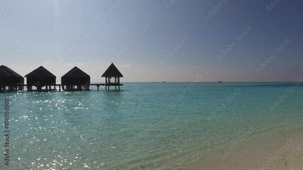 bungalow huts in sea on tropical resort beach bungalow huts in sea on tropical resort beach