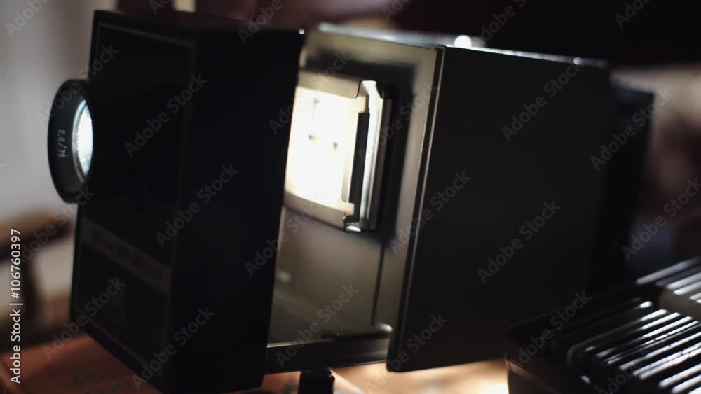 Man shows photos on the slide projector 