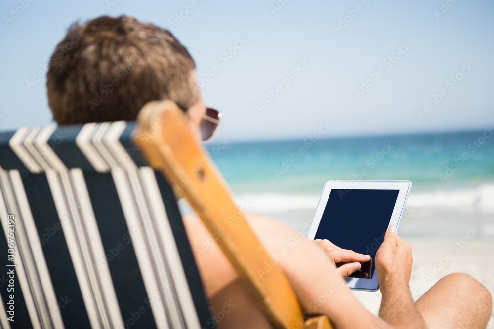 Man relaxing and using tablet