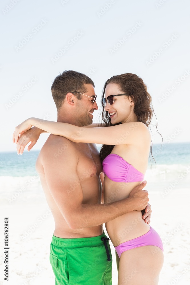 Smiling couple hugging on the beach Smiling couple hugging on the beach