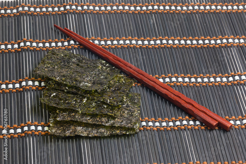 Roasted seaweed snack (kim nori) on bamboo mat
 photo