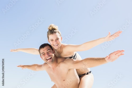 Boyfriend giving piggy back to girlfriend