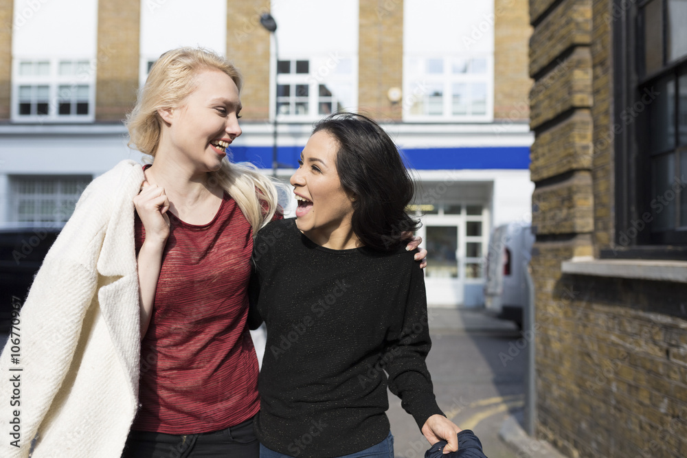 Two female best friends having fun on urban street Two female best friends having fun on urban street