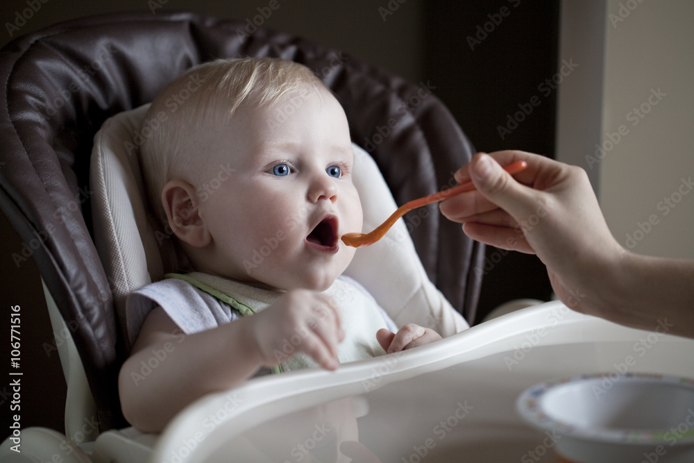 baby boy sitting at a table for feeding baby boy sitting at a table for feeding