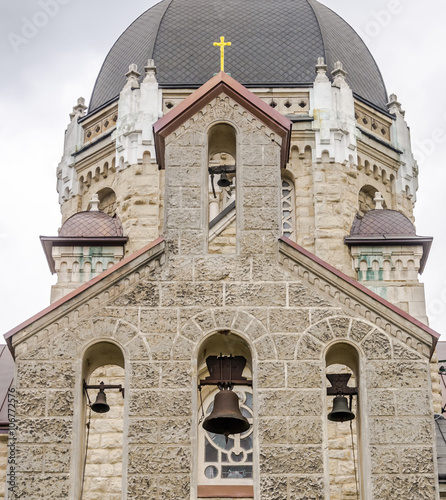 Stone church building with domes, bells and crosses Ascension Church in Lviv, Ukraine photo